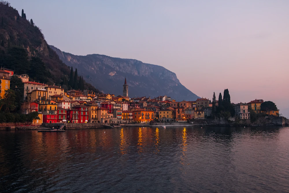 Lake Como village lights reflected across still evening water