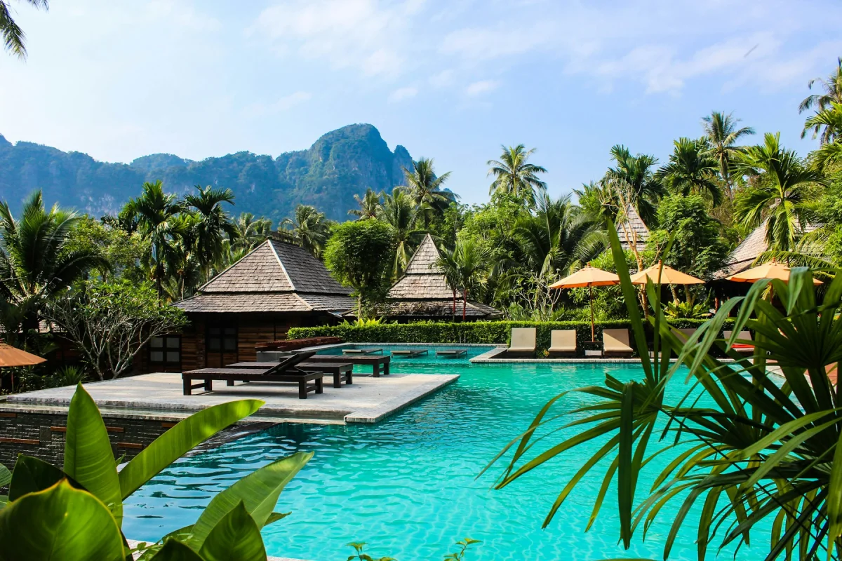 Tropical all-inclusive resort pool surrounded by palm trees