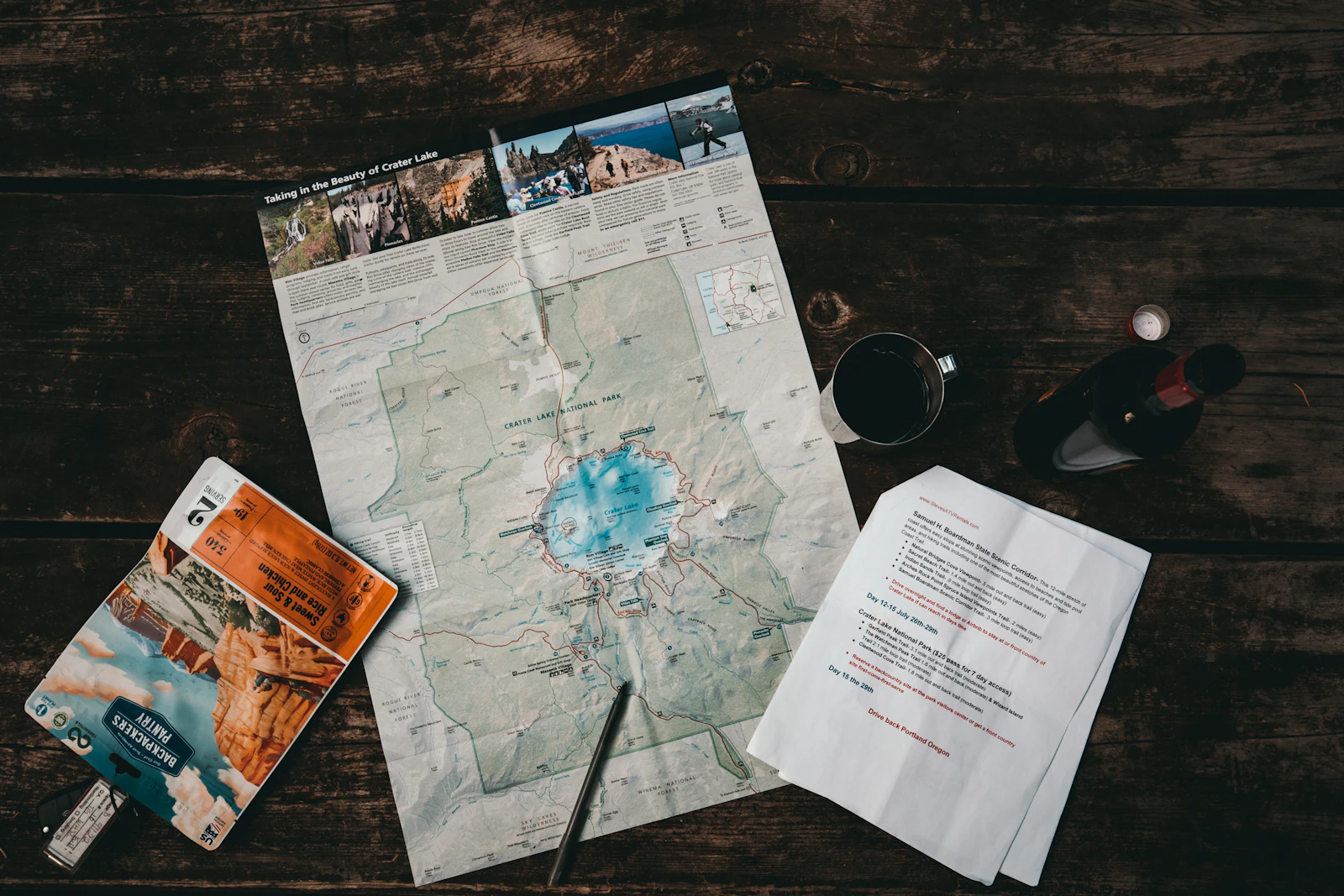 Paper map and travel notes arranged on a wooden table